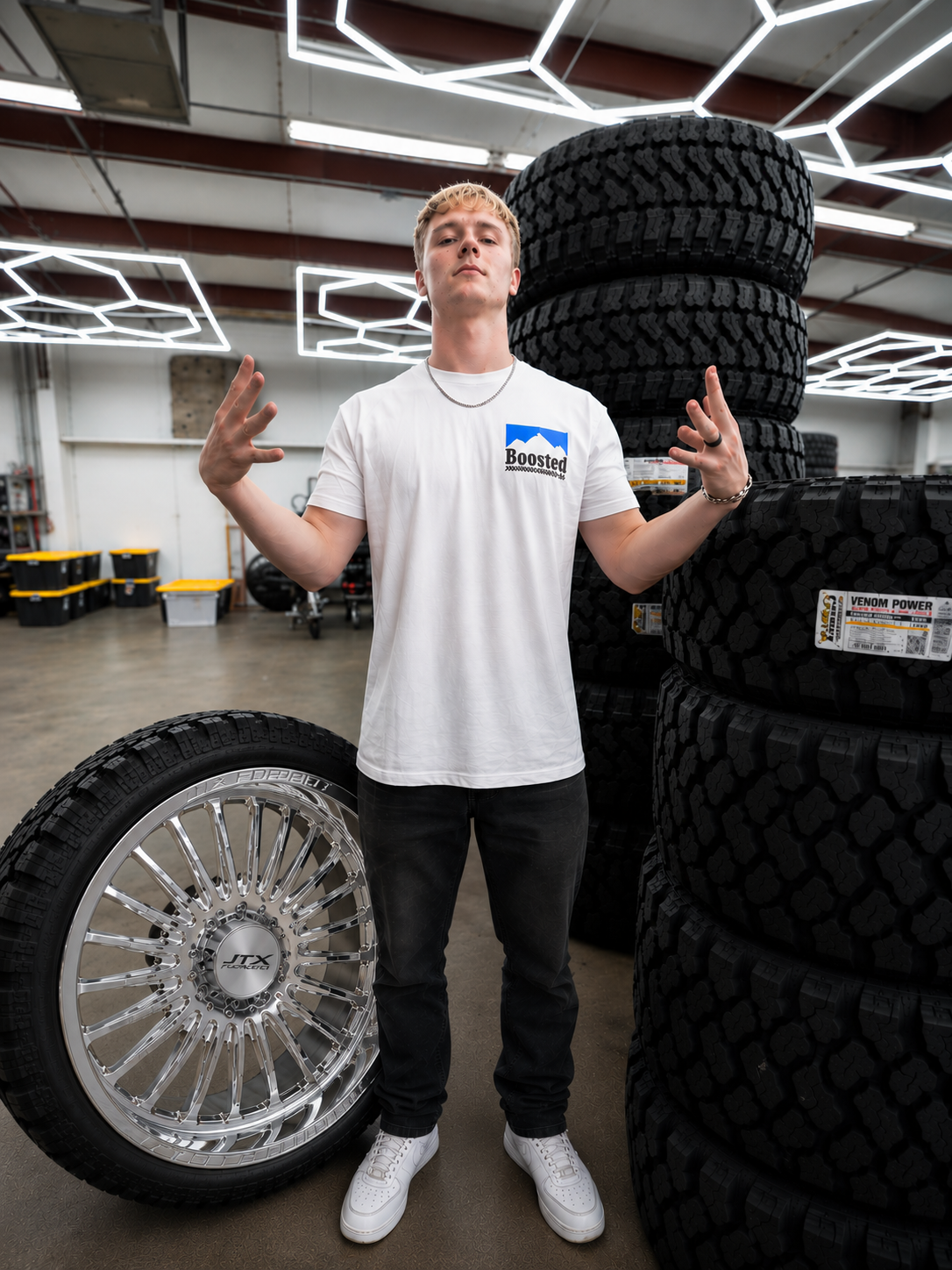 Emerson Nix standing next to a set of JTX wheels, the grand prize of Shop Boosted #1