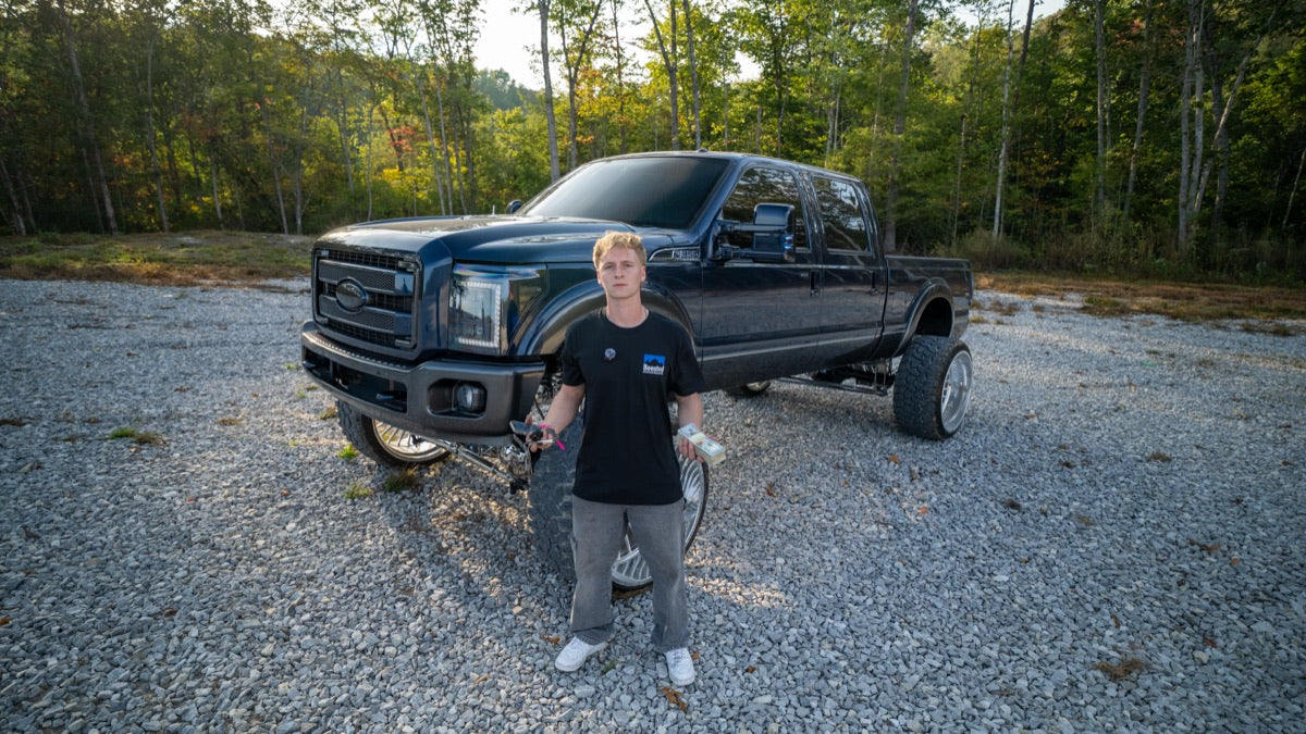 Emerson Nix standing in front of Blue Collar on the gravel lot