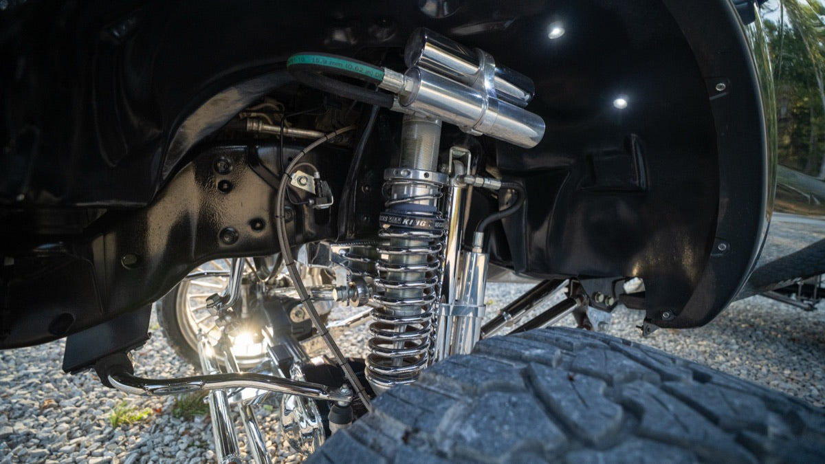 Chrome coilover shock and steering detail inside the front wheel well