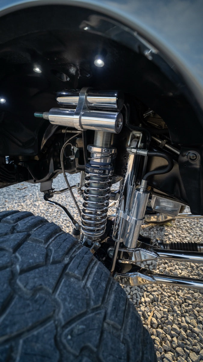 Chrome shock and suspension linkage detail in the wheel well