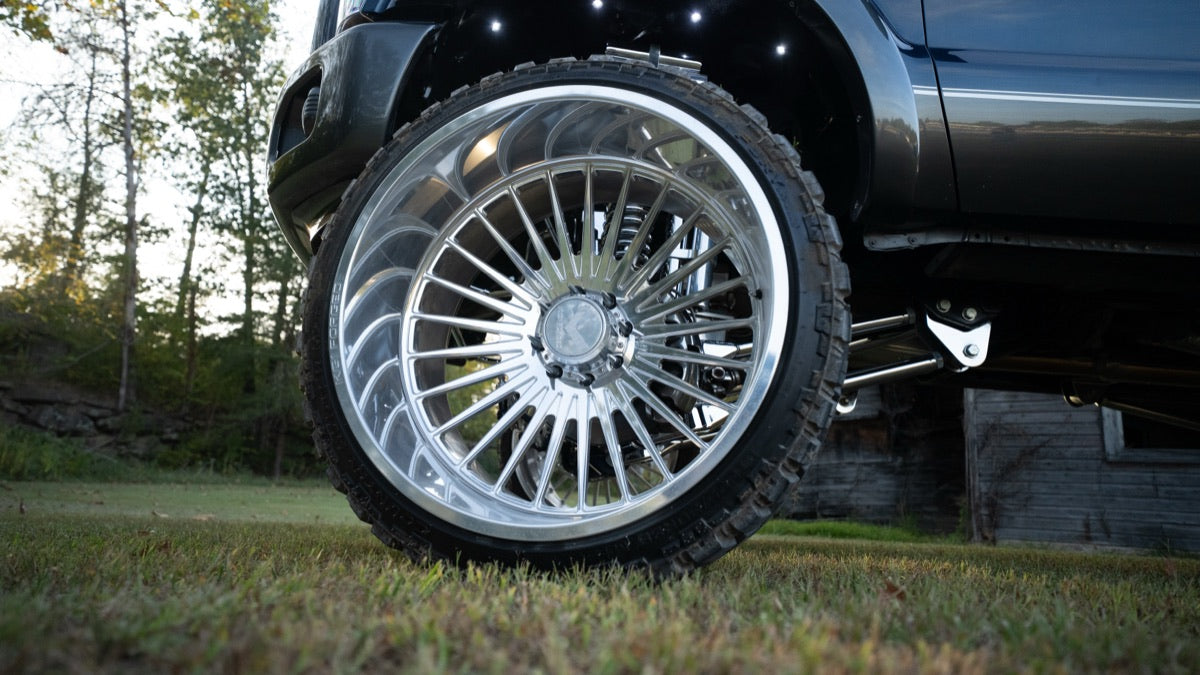 Polished wheel close-up on grass in front of the barn