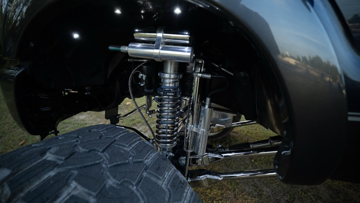 Shock and suspension detail in the wheel well on grass