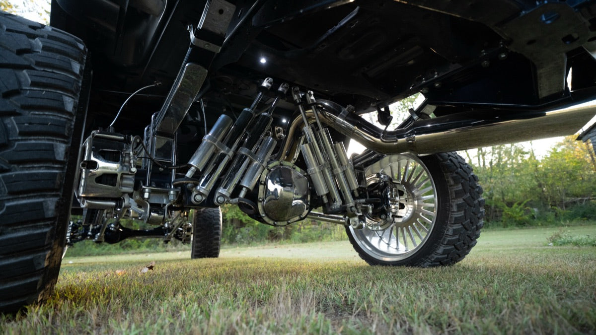 Rear suspension and driveline from a low angle on grass
